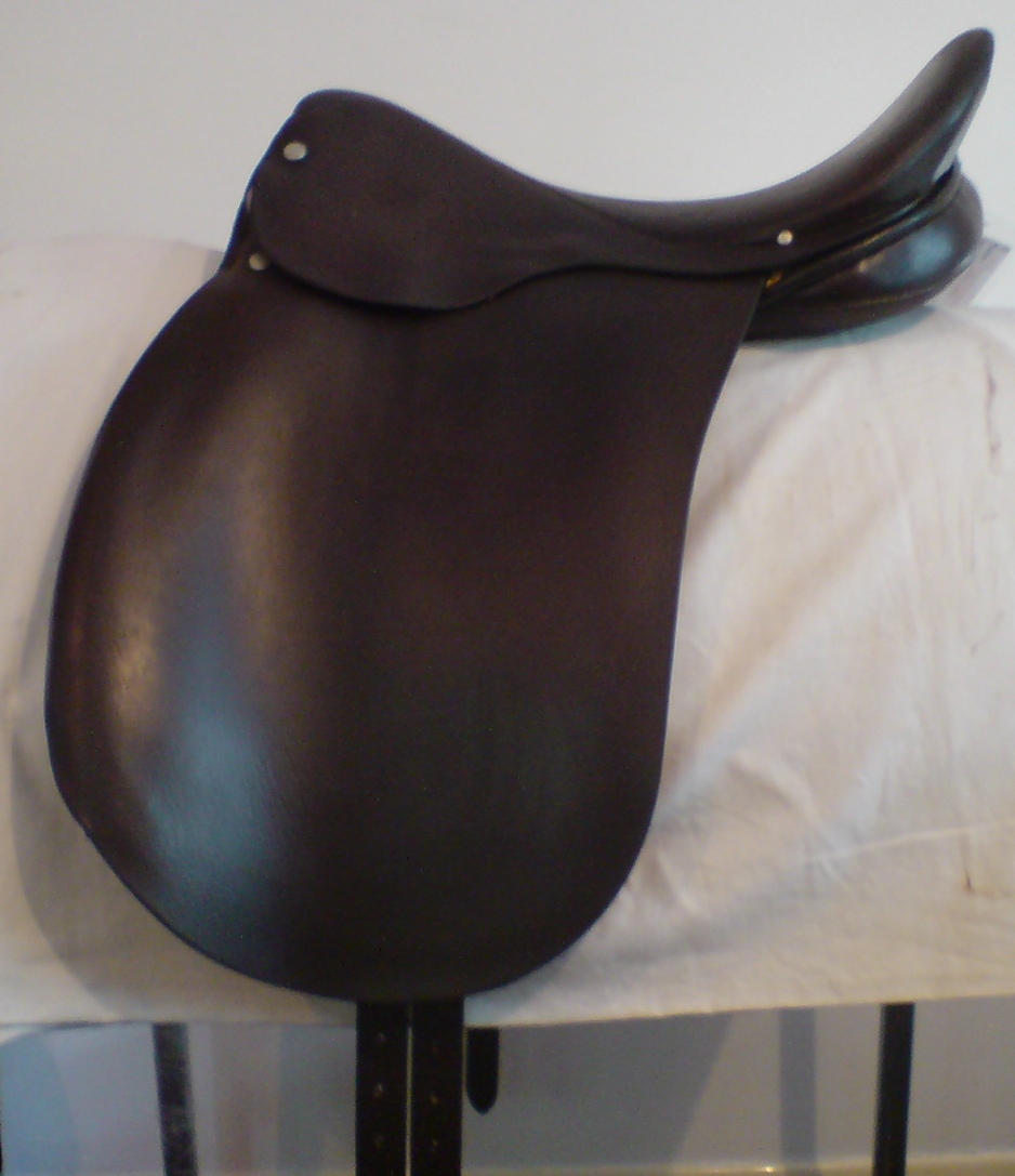 Dressage saddle — straight-cut flap, deep centered seat