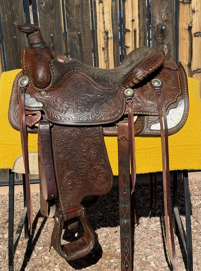 Western roping saddle — tooled leather, large horn, heavy construction